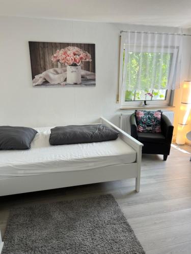 a living room with a bed and a chair at Apartment Nr. 5 am Stuttgarter Flughafen/Messe in Leinfelden-Echterdingen