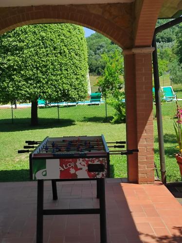 a table sitting on a patio in a park at Il Colombaiolo in Castelmuzio