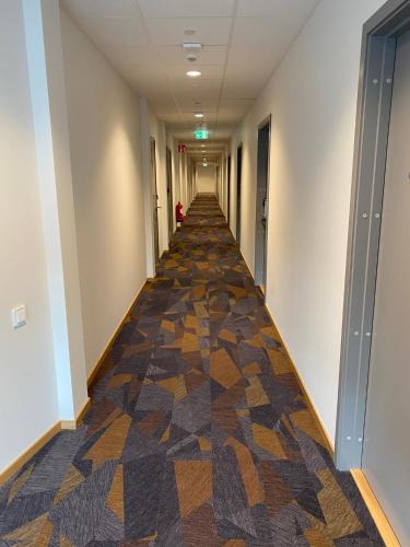 a hallway of an office building with a carpeted corridor at Ahlgrens Hotell Bed & Breakfast in Gävle