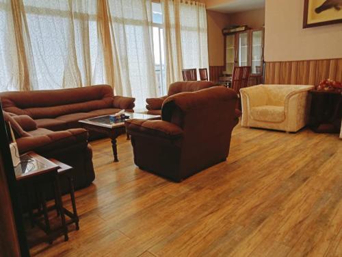 a living room with a couch and chairs and a table at Panorama Luxury House in Nathia Gali