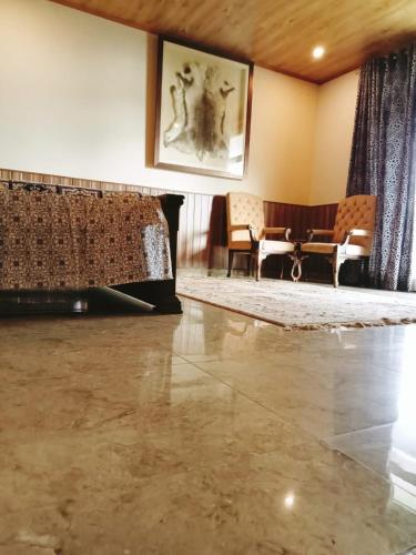 a room with a marble floor and a table and chairs at Panorama Luxury House in Nathia Gali