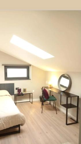 um quarto com uma cama, um espelho e uma cadeira em Live Attic room em Somma Vesuviana