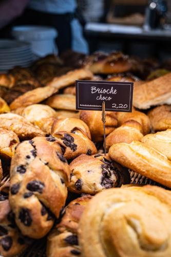 a display of various types of pastries in a bakery at unique by ATLANTIC Hotels Kiel in Kiel