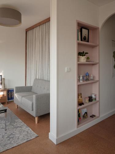 a living room with a couch and a chair at L'heure Bleue - Meublé de tourisme 3 étoiles in Royat