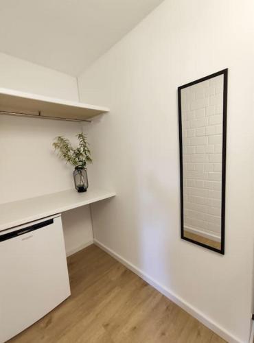 a white room with a shelf and a mirror at Sauna, Pools mit XXL-Terasse oder Kinderkino in Sankt Englmar