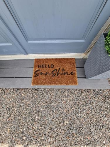 a welcome mat on the front of a house at Firbog Nook in Antrim