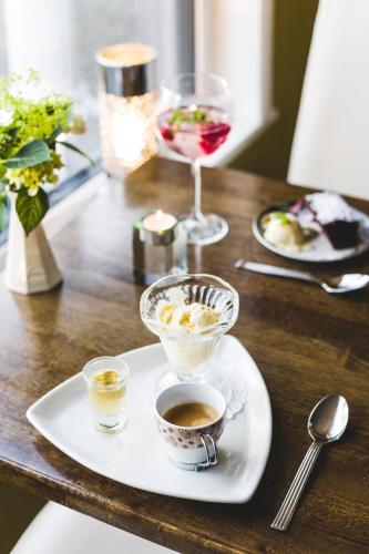 a table with two cups of coffee and a glass of wine at Lios Na Manach ECO B&B in Killarney