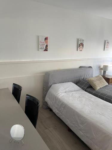 a bedroom with two beds and a table with chairs at Maipo 1501 in Buenos Aires