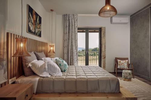 a bedroom with a large bed and a window at Villa Arianna, close to the beach! in Kalamaki