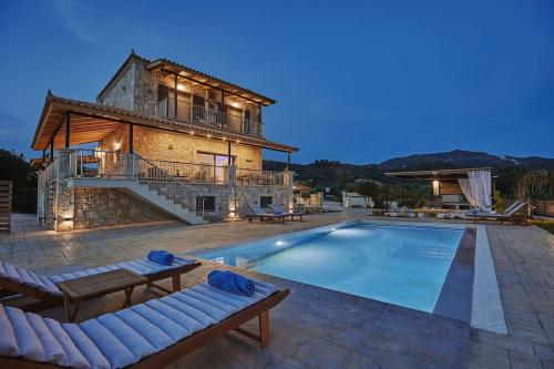 a villa with a swimming pool and a house at Villa Arianna, close to the beach! in Kalamaki