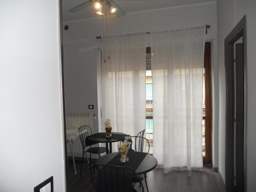 a dining room with a table and chairs and a window at Sweet Rome B&B in Rome