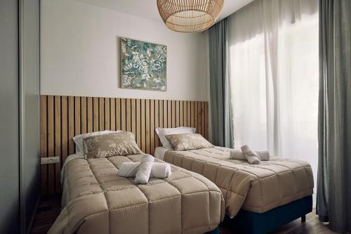 a bedroom with two beds in a room at Villa Arianna, close to the beach! in Kalamaki