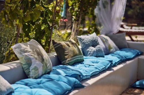 a row of pillows sitting on a bench at Villa Arianna, close to the beach! in Kalamaki