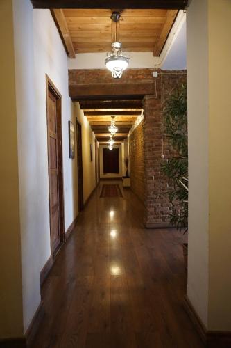 an empty hallway with a brick wall and wooden ceilings at Old Sighnaghi in Sighnaghi