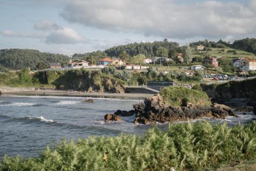 a view of a beach with rocks in the water at Bellamar Playa Santa Maria in Naveces