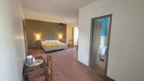 a bedroom with a bed and a table and a mirror at Domaine Ostriconi in Palasca