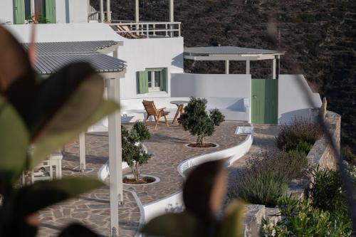 a view of a house with a patio with trees at Castello Amorgos Suites in Katapola