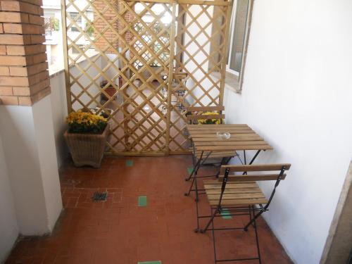 a balcony with two benches and a table and a window at Sweet Rome B&B in Rome