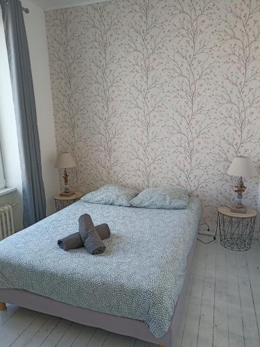 a bedroom with a bed with two towels on it at Centre in Brest