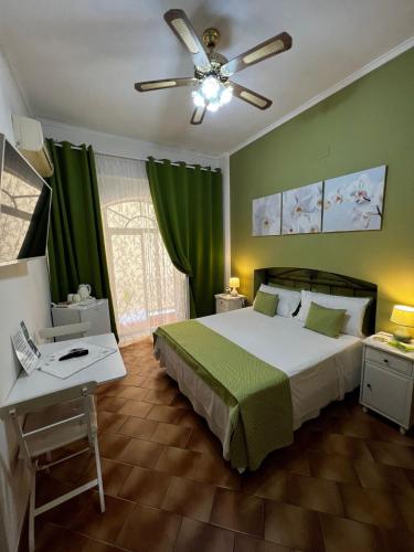 a bedroom with a bed and a ceiling fan at CASA DEL SOLE Accomodation in Tropea