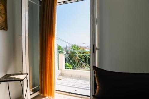 an open sliding glass door with a view of a balcony at Nous Dios in Xilokéra