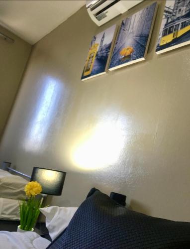 a bedroom with two beds and pictures on the wall at Hotel La Terminal in San Miguel de Tucumán