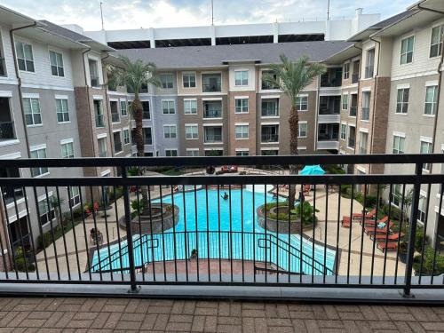 a view of a pool from a balcony of a building at Domain at Kirby in Houston