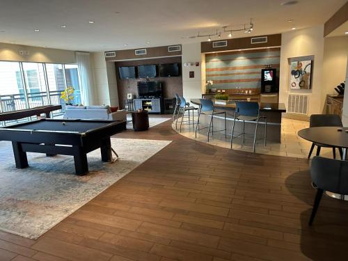a living room with a pool table and a kitchen at Domain at Kirby in Houston