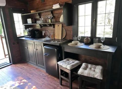 a kitchen with a counter and a stove top oven at Roulotte / Tiny House dans les Alpilles in Saint-Rémy-de-Provence