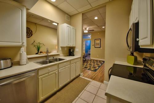 una cocina con armarios blancos y fregadero en Turner's loft / sleeps 4 in the heart of the town en Wilmington