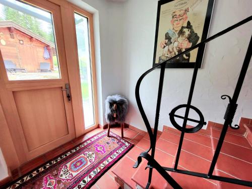 a dog standing in front of a door at Schickster Sky Lodge in Leutasch