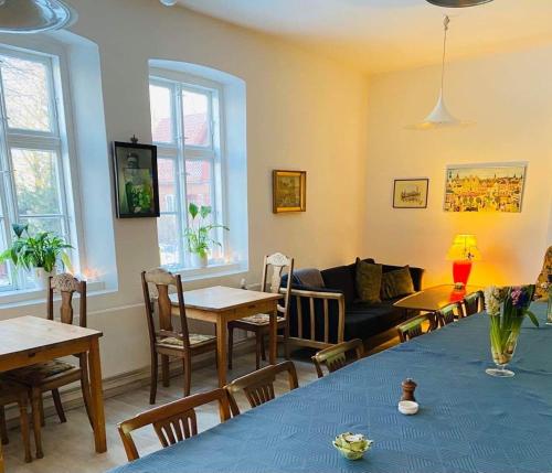 a living room with a couch and a table and chairs at Bellinge House in Horreby