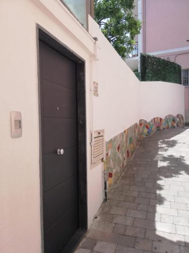 a black door on the side of a white building at Casa vacanze Amalfitan Coast in Vietri sul Mare
