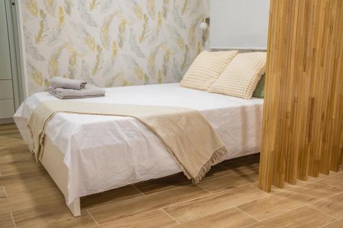 a bed with white sheets and pillows in a bedroom at LM27 Beach "Little Blondies" in Las Palmas de Gran Canaria