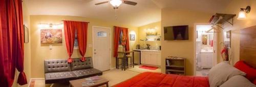 a living room with a couch and red curtains at talkeetna villas and tours in Talkeetna