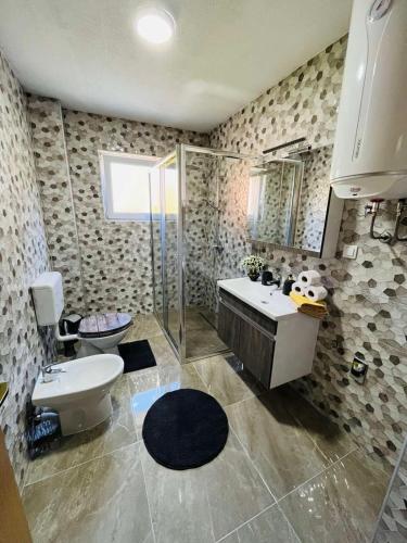 a bathroom with a toilet and a sink and a shower at Summer house LejHana in Bihać