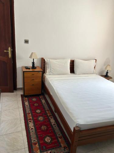a bedroom with a bed with a nightstand and a bed sidx sidx at Casa Medina Sanaa in Tetouan