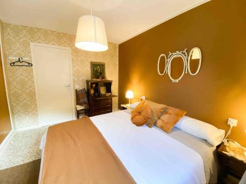 a bedroom with a large white bed with pillows on it at Típica Casa Andorrana en Encamp l by BonesVacances in Encamp