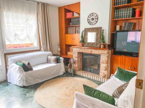 a living room with white furniture and a fireplace at Típica Casa Andorrana en Encamp l by BonesVacances in Encamp