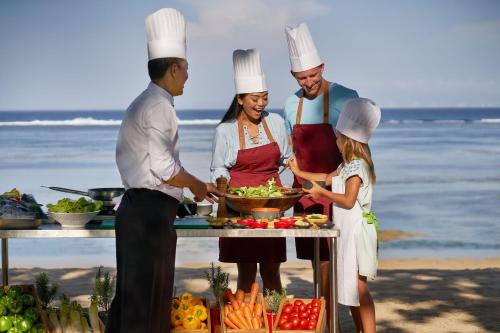 a group of chefs preparing food on the beach at The Westin Resort Nusa Dua, Bali in Nusa Dua