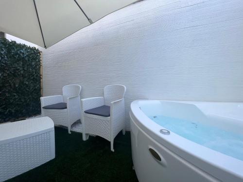 維拉西繆斯的住宿－Via Giardini Rooms，一间带椅子和浴缸的浴室