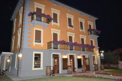 a large building with flowers on the balconies at night at Locanda La Sosta in Cavaion Veronese