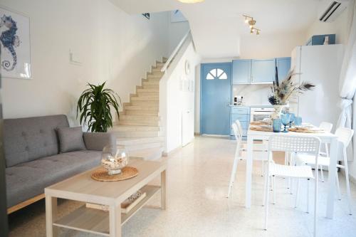 a living room with a couch and a table at Ocean Blue House 17 in Meneou