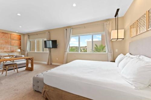 a bedroom with a large white bed and a table at 7478 Magic Village 8guests 4suites 8min Disney in Orlando