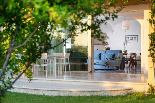 a living room and dining room with a blue couch at OraBlu Exclusive Villas in Ischia
