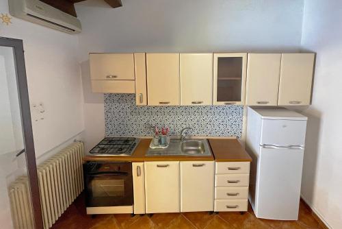 a small kitchen with a sink and a refrigerator at Luxury Apartments Campofelice in Campofelice di Roccella