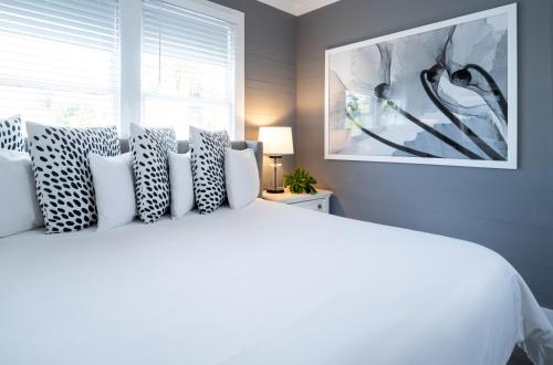 a bedroom with a white bed with pillows and a window at Alexander's Guesthouse-Adult Exclusive, LGBTQ Friendly in Key West