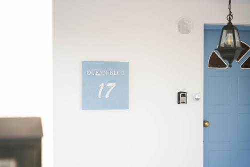a sign on the door of an open clinic at Ocean Blue House 17 in Meneou