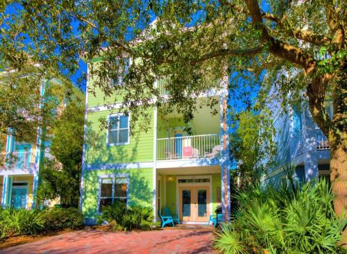 a large green house with a tree in front of it at Seas The Dream at The Villages of Crystal Beach in Destin