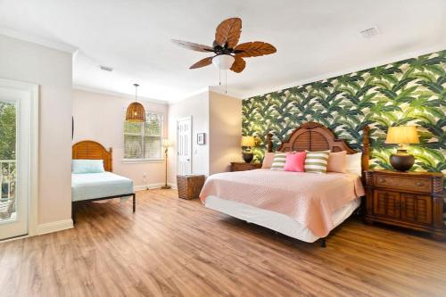 a bedroom with a large bed and a fan at Seas The Dream at The Villages of Crystal Beach in Destin